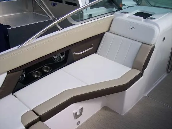 Slide: The Image of 2014 Regal 24 FasDeck boat interior with beige and white seating. - 13
