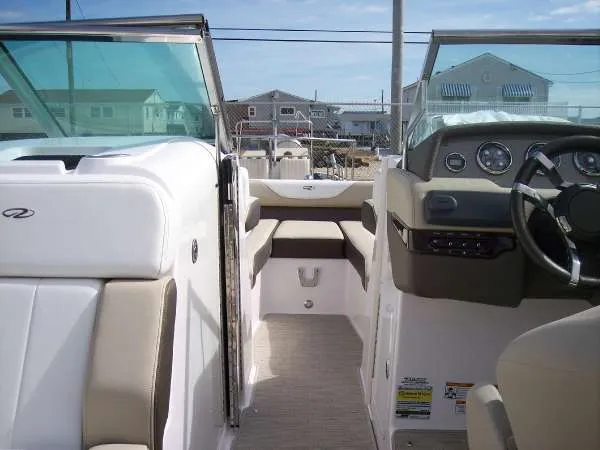 Slide: The Image of 2014 Regal 24 FasDeck boat interior with beige seating and modern dashboard. - 16