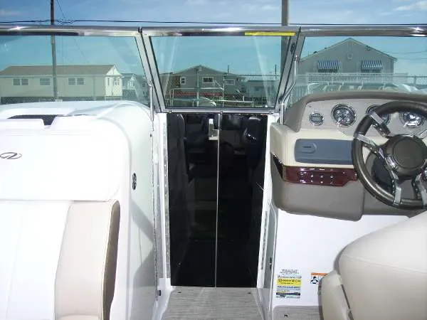 Slide: The Image of 2014 Regal 24 FasDeck boat interior with steering wheel and dashboard view. - 17