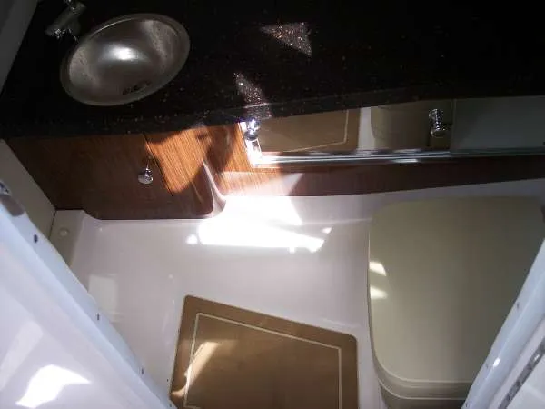Slide: The Image of 2014 Regal 24 FasDeck boat interior with sink and toilet. - 19