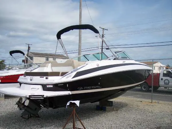 Slide: The Image of 2014 Regal 24 FasDeck boat on display, featuring sleek black and white design. - 3