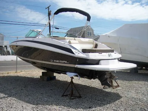 Slide: The Image of 2014 Regal 24 FasDeck boat on stands, displayed outdoors on gravel. - 4