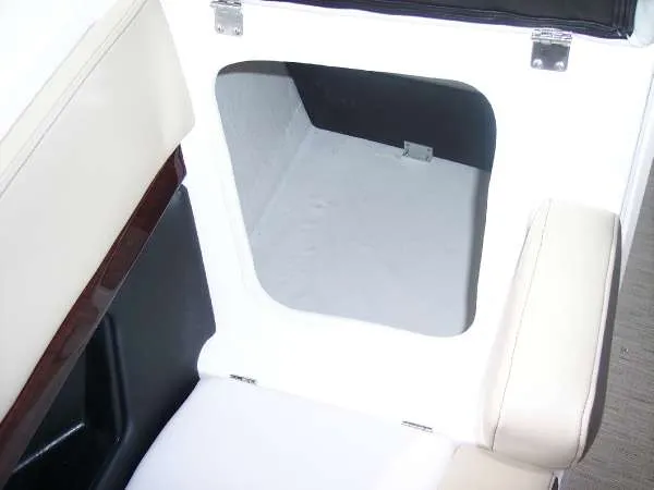 Slide: The Image of 2014 Regal 24 FasDeck storage compartment with white interior and cushioned seating. - 8