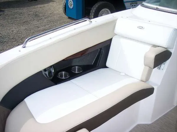 Slide: The Image of 2014 Regal 24 FasDeck boat interior with white and beige seating, cup holders, and sleek design. - 9