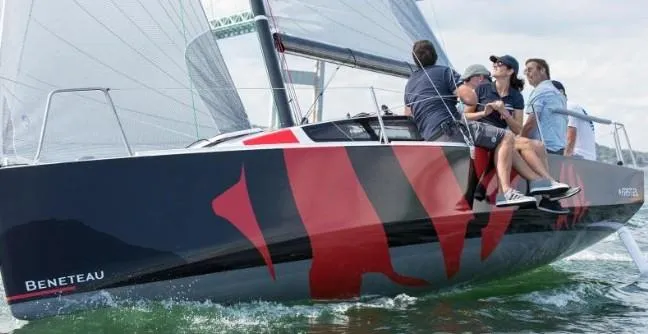 Slide: The Image of 2026 Beneteau First 24 sailboat with crew navigating on water. - 3