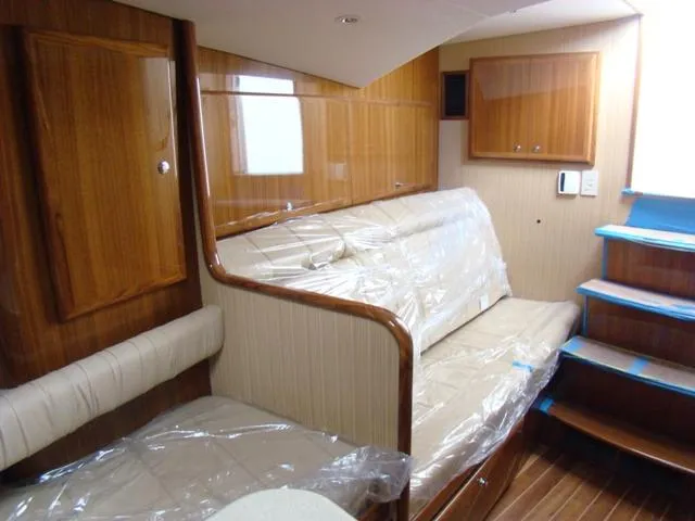 Slide: The Image of 2024 Jersey Cape Devil 36 Custom interior with wooden cabinetry and cushioned seating. - 10