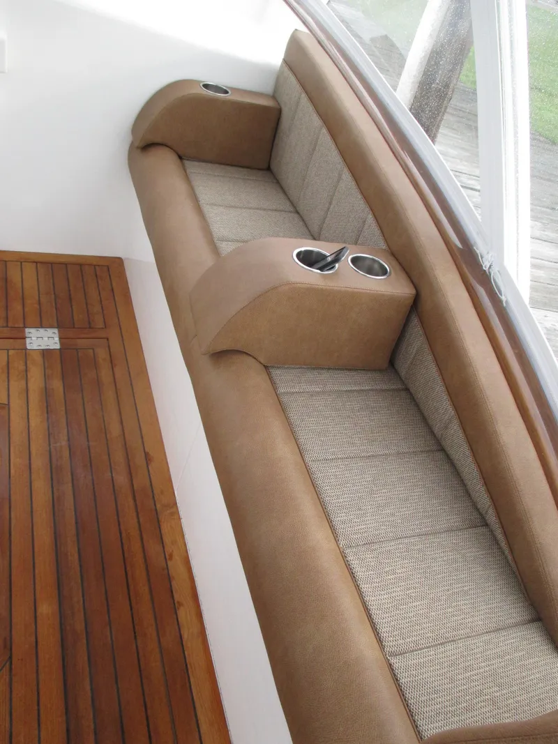 Slide: The Image of 2024 Jersey Cape Devil 36 Custom boat interior with cushioned seating and wooden flooring. - 18