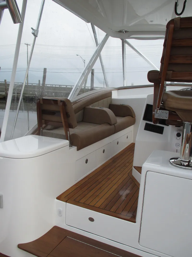 Slide: The Image of 2024 Jersey Cape Devil 36 Custom boat interior with wooden flooring and cushioned seating. - 25