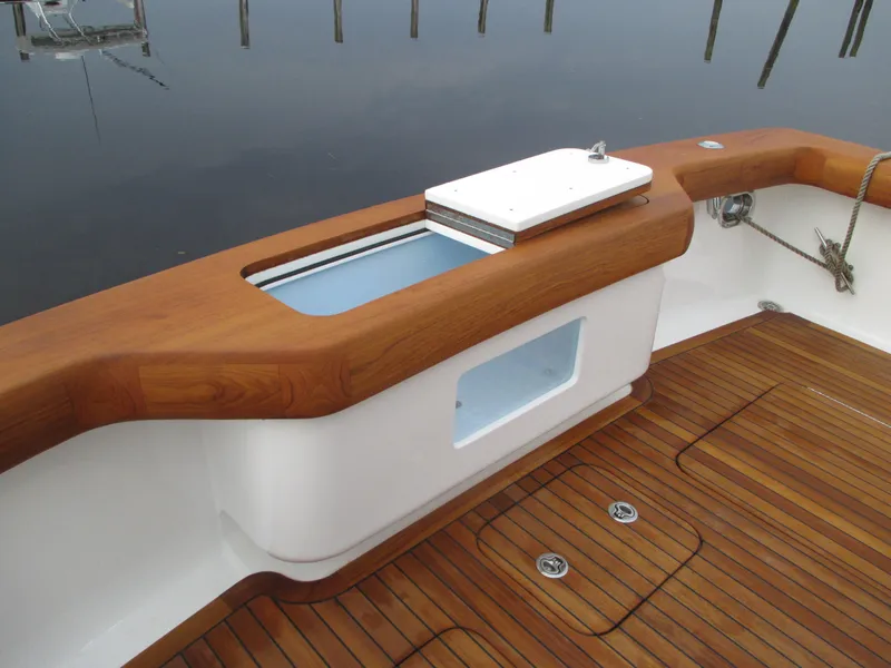 Slide: The Image of 2024 Jersey Cape Devil 36 Custom boat deck with wooden finish and storage compartment. - 26