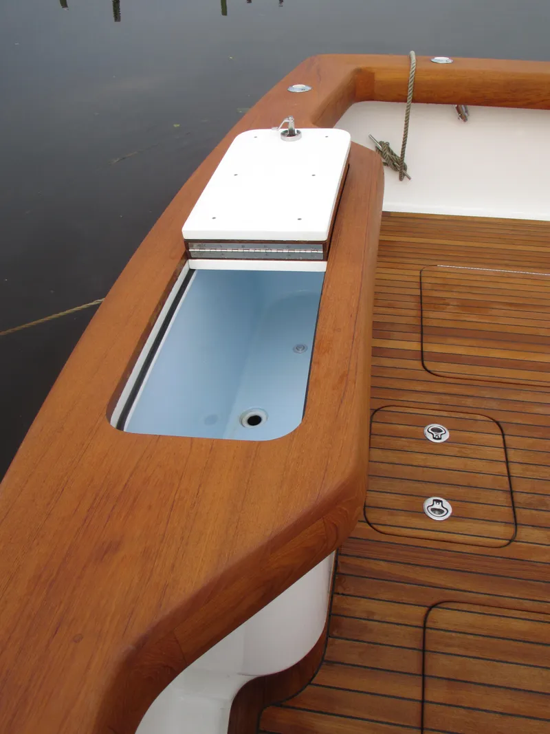 Slide: The Image of 2024 Jersey Cape Devil 36 Custom boat deck with wooden finish and storage compartment. - 27