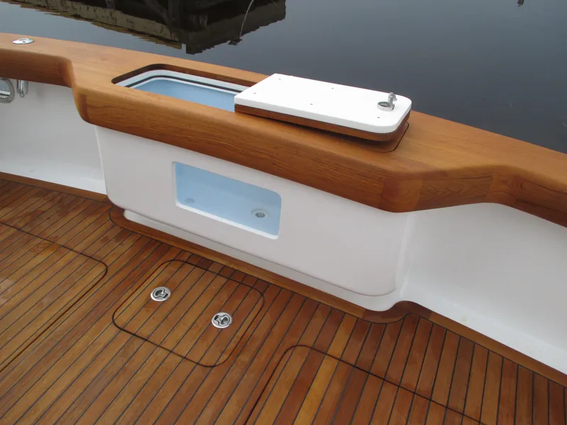 Slide: The Image of Jersey Cape Devil 36 Custom 2024 boat deck with teak flooring and storage compartments. - 28