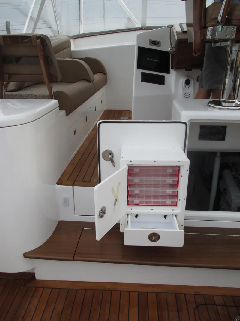 Slide: The Image of 2024 Jersey Cape Devil 36 Custom boat interior with open storage compartment. - 37