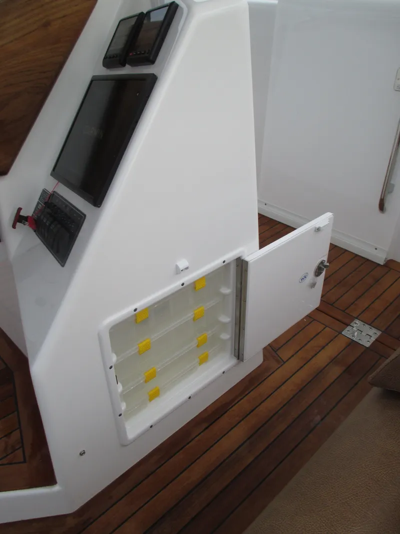 Slide: The Image of 2024 Jersey Cape Devil 36 Custom boat interior with open storage compartment. - 40