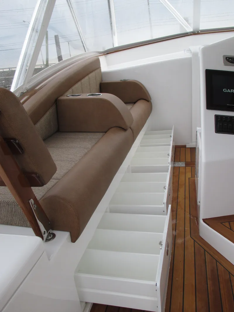 Slide: The Image of 2024 Jersey Cape Devil 36 Custom boat interior with storage drawers and cushioned seating. - 41