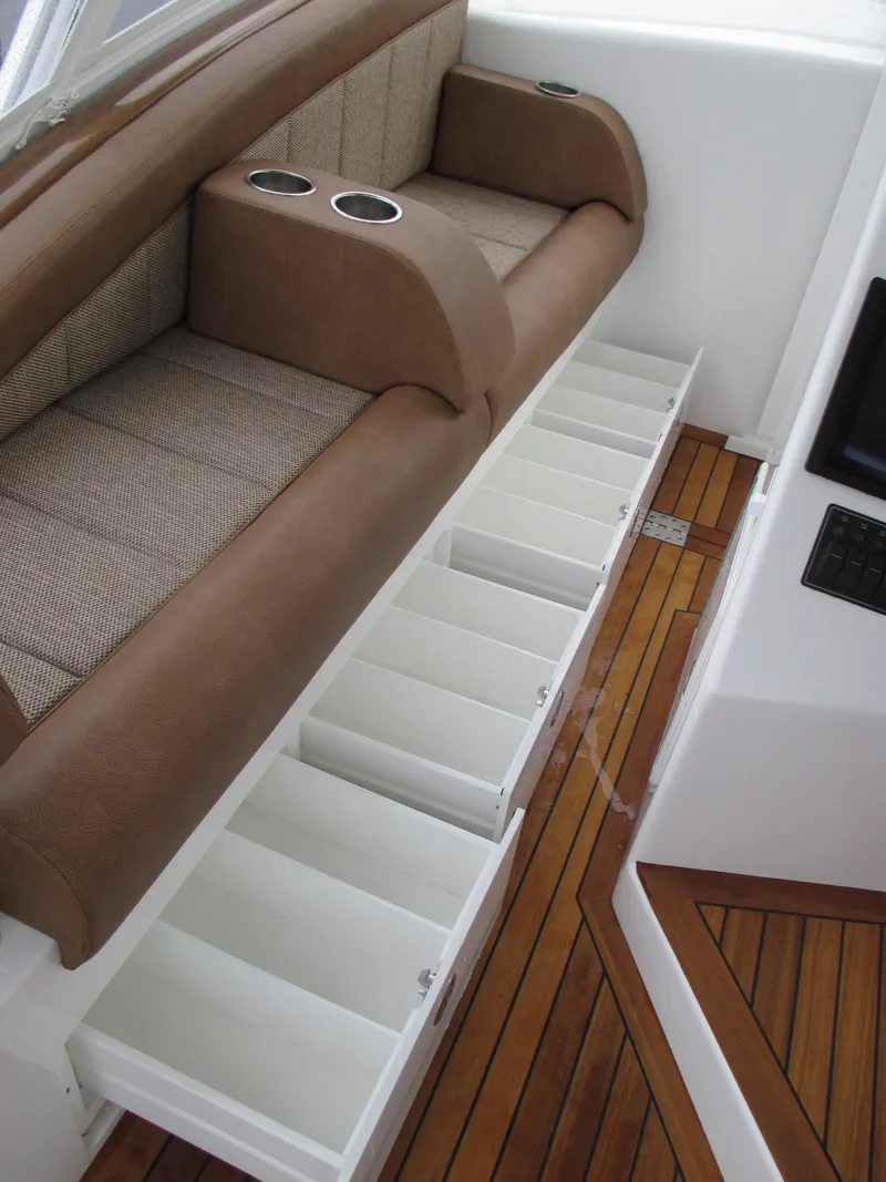 Slide: The Image of 2024 Jersey Cape Devil 36 Custom boat interior with storage compartments and cushioned seating. - 42