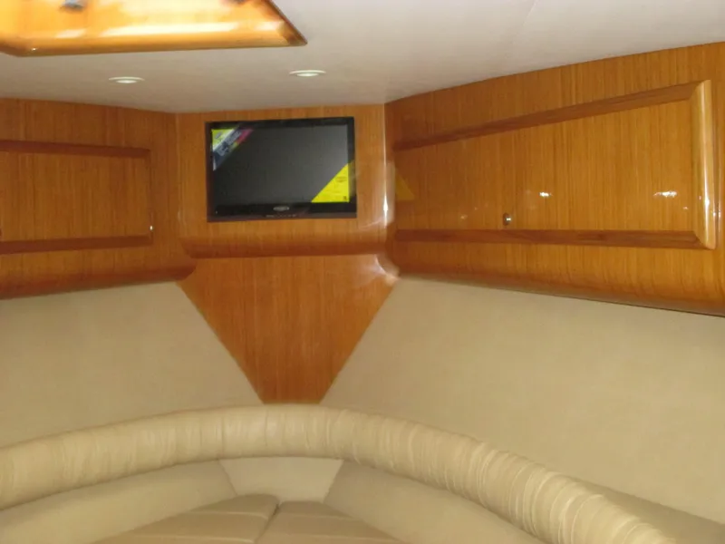 Slide: The Image of 2024 Jersey Cape Devil 36 Custom interior with TV and wooden cabinetry. - 47