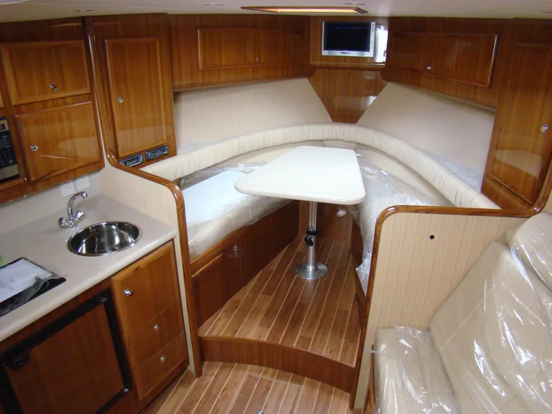 Slide: The Image of 2024 Jersey Cape Devil 36 Custom interior with wood cabinetry and seating area. - 9