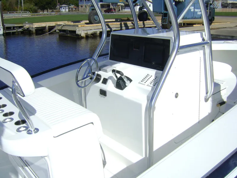 Slide: The Image of 2024 Jersey Cape 31 Little Devil boat interior with steering console and seating. - 13