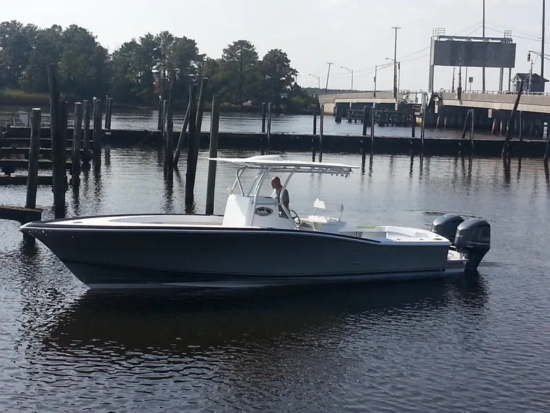 Slide: The Image of 2024 Jersey Cape 31 Little Devil boat on calm water near a dock. - 20