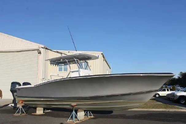 Slide: The Image of 2024 Jersey Cape 31 Little Devil boat on stands outside a warehouse. - 36