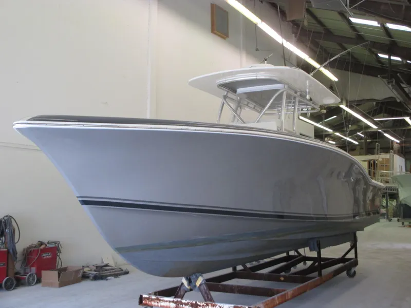 Slide: The Image of 2024 Jersey Cape 31 Little Devil boat in a warehouse. - 39