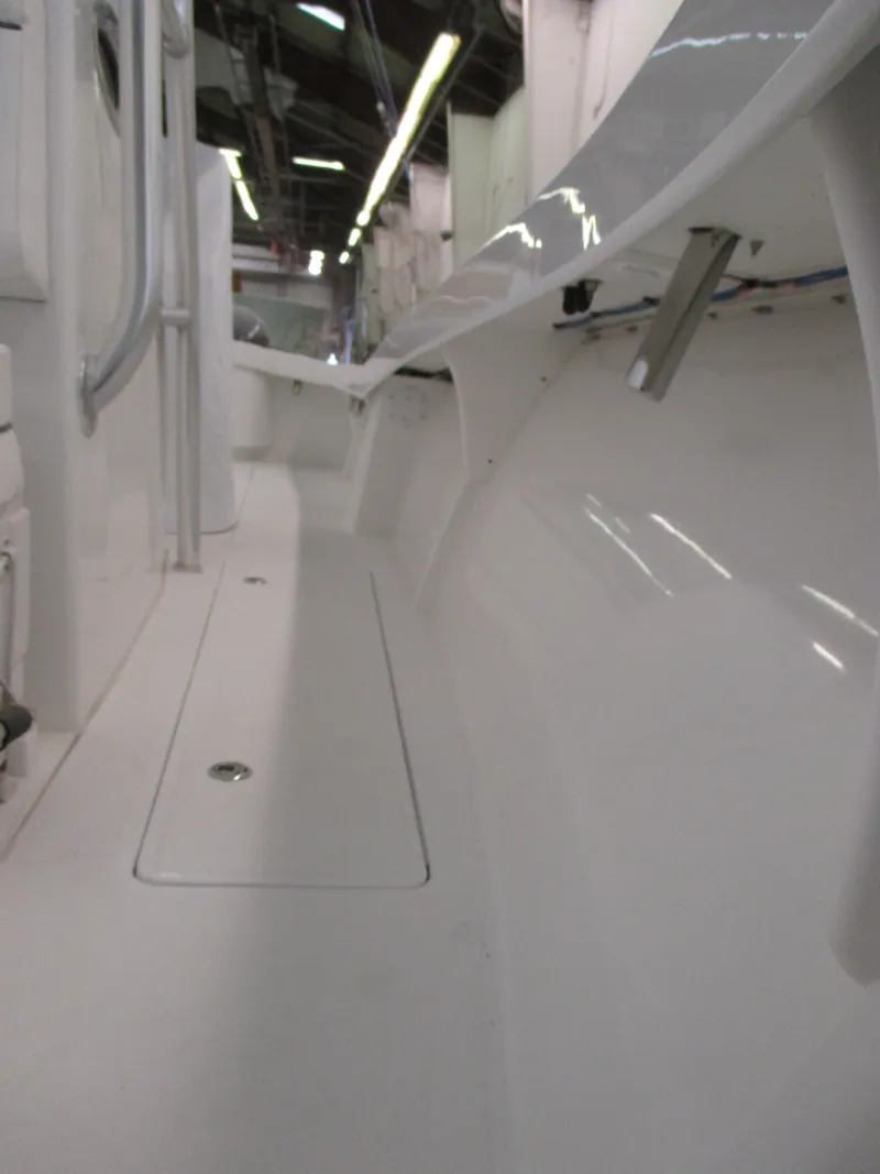 Slide: The Image of 2024 Jersey Cape 31 Little Devil boat interior, white deck and storage compartments. - 40