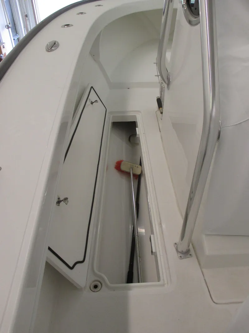 Slide: The Image of 2024 Jersey Cape 31 Little Devil boat storage compartment with cleaning brush. - 41