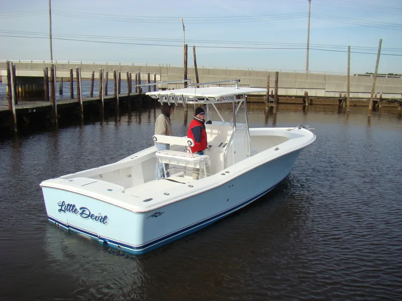 Slide: The Image of 2024 Jersey Cape 31 Little Devil boat on the water with two people onboard. - 42