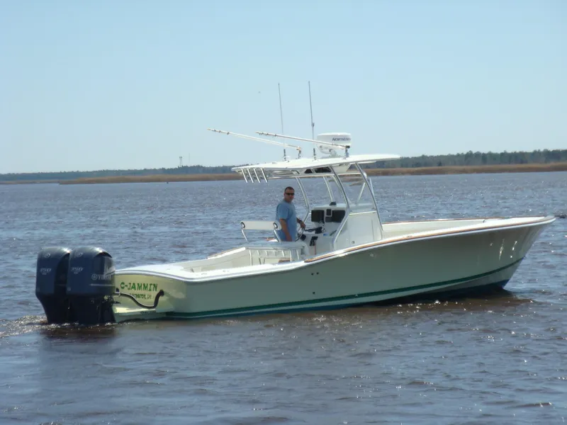 Slide: The Image of 2024 Jersey Cape 31 Little Devil boat on water with dual outboard motors. - 43