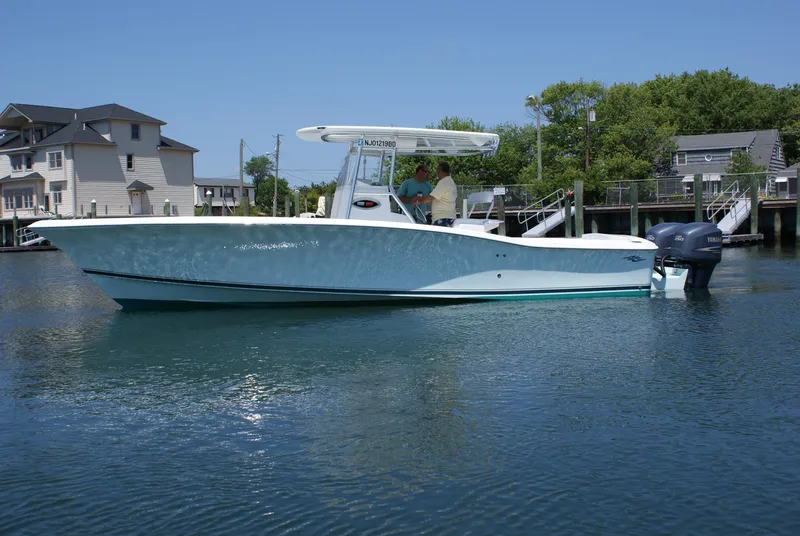 Slide: The Image of 2024 Jersey Cape 31 Little Devil boat on calm water near docks and houses. - 8