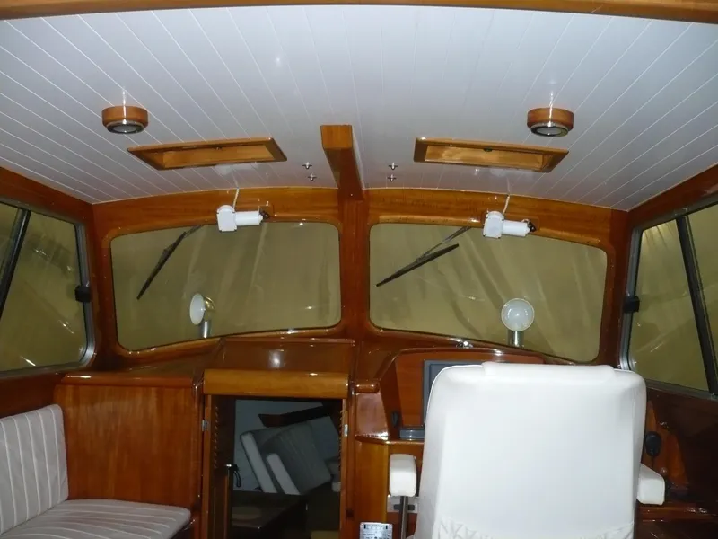 Slide: The Image of Interior of a 1999 Classic Coaster Picnic Boat with wooden accents and seating. - 11