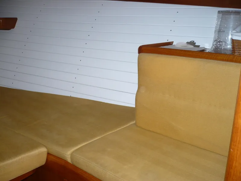 Slide: The Image of Interior of 1999 Classic Coaster Picnic Boat with beige seating and wooden accents. - 19