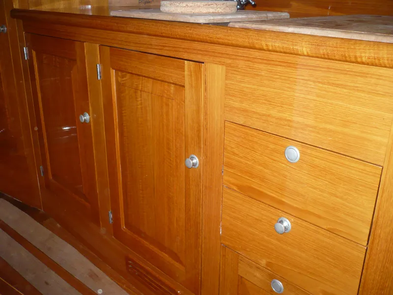 Slide: The Image of Wooden cabinetry inside a 1999 Classic Coaster Picnic Boat, featuring polished knobs and a smooth finish. - 22