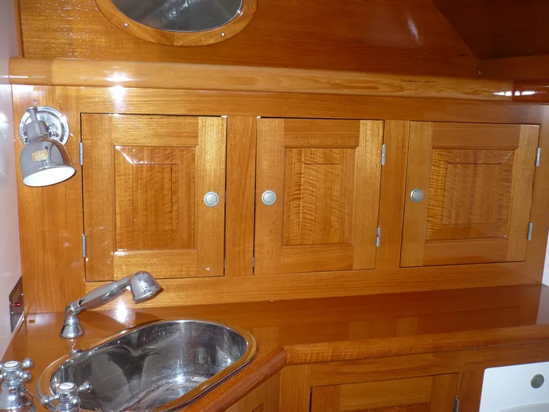 Slide: The Image of Wooden cabinetry and sink in 1999 Classic Coaster Picnic Boat interior. - 23