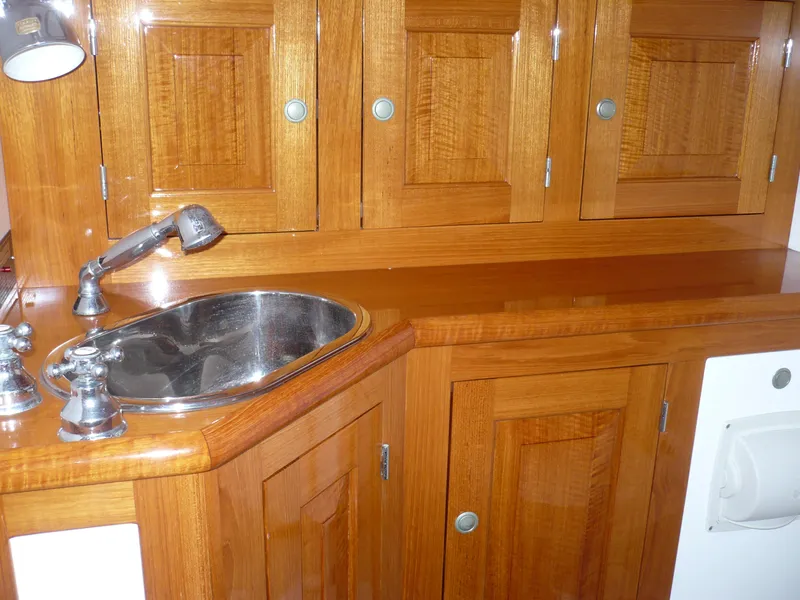 Slide: The Image of Wooden cabinetry and sink in 1999 Classic Coaster Picnic Boat interior. - 24