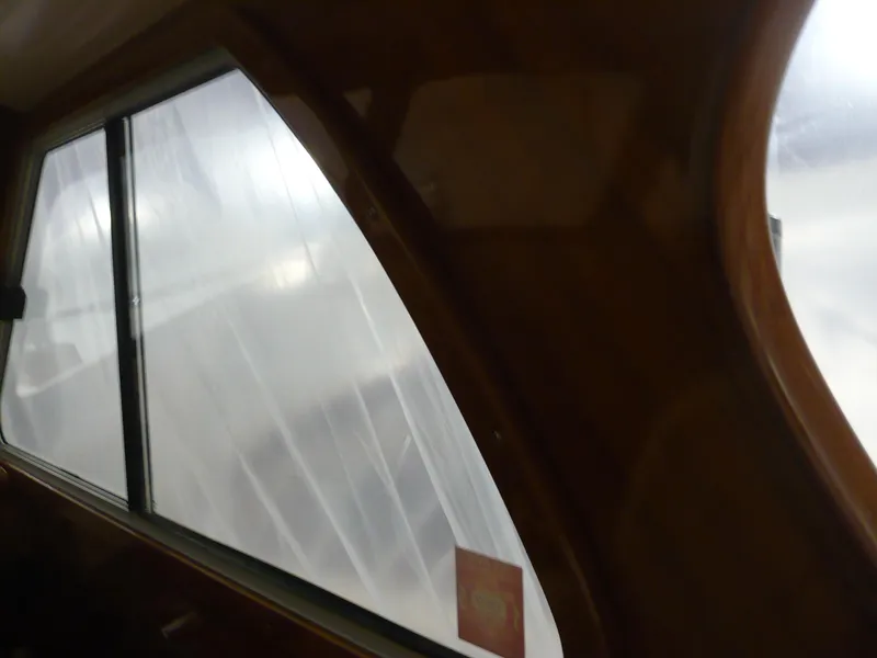 Slide: The Image of Interior view of a 1999 Classic Coaster Picnic Boat window with wooden frame. - 28