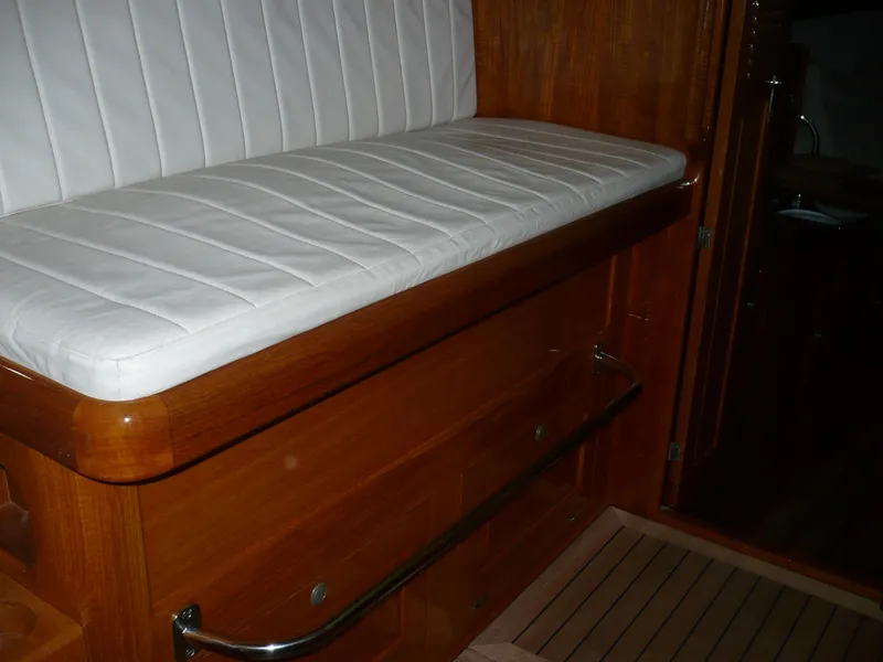 Slide: The Image of White cushioned seat on 1999 Classic Coaster Picnic Boat with wooden interior. - 30