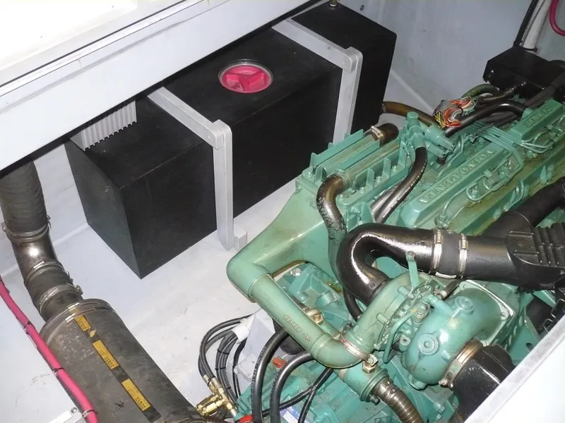 Slide: The Image of Engine compartment of a 1999 Classic Coaster Picnic Boat with visible components and wiring. - 32