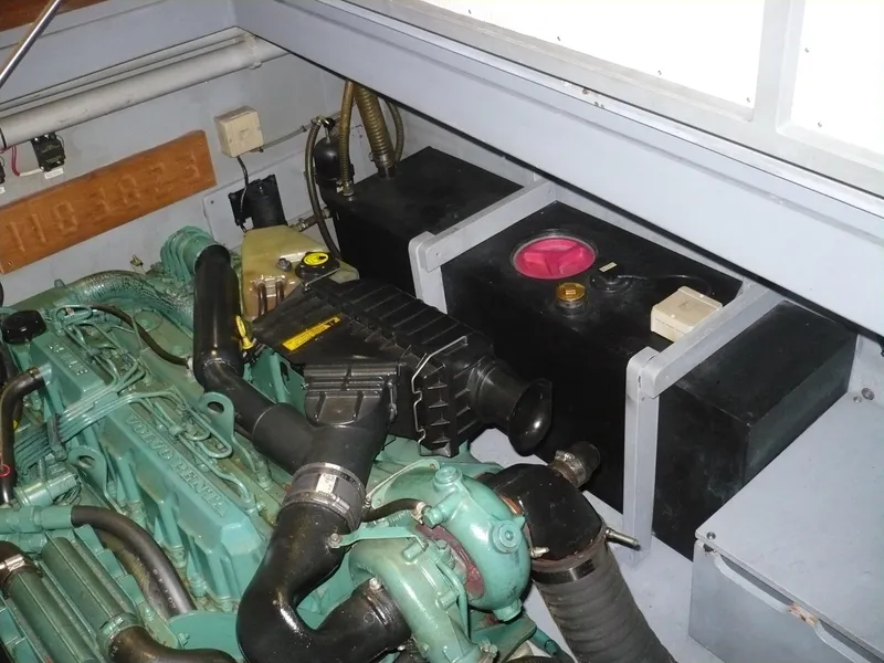 Slide: The Image of Engine compartment of a 1999 Classic Coaster Picnic Boat, showcasing mechanical components. - 33