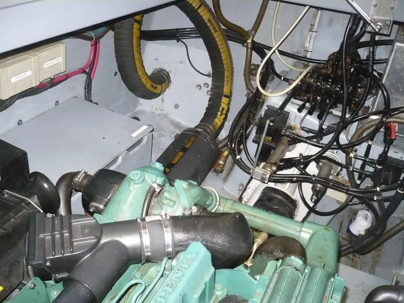 Slide: The Image of Engine compartment of a 1999 Classic Coaster Picnic Boat with visible wiring and components. - 34