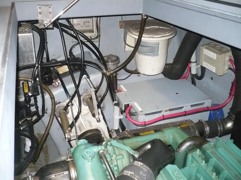 Slide: The Image of Engine compartment of a 1999 Classic Coaster Picnic Boat, showcasing mechanical components and wiring. - 35