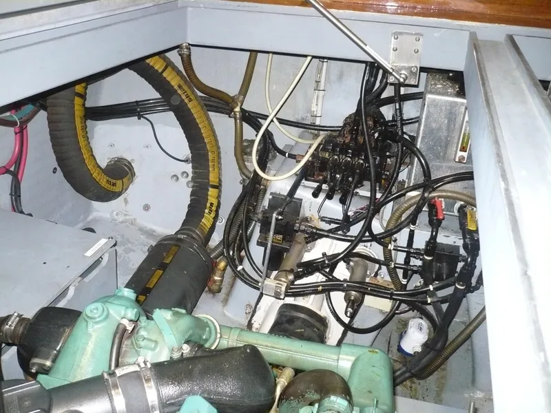 Slide: The Image of Engine compartment of a 1999 Classic Coaster Picnic Boat, showcasing mechanical components and wiring. - 36