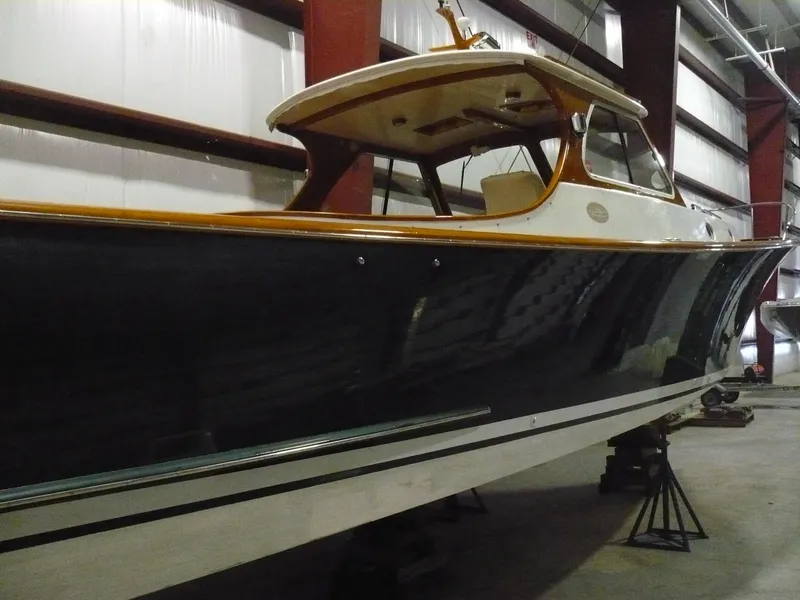 Slide: The Image of 1999 Classic Coaster Picnic Boat in storage, showcasing sleek design and elegant craftsmanship. - 39