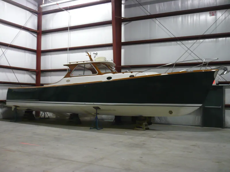 Slide: The Image of 1999 Classic Coaster Picnic Boat in storage, showcasing sleek design and craftsmanship. - 40