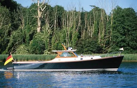 Slide: The Image of Classic Coaster 1999 Picnic Boat cruising on a serene lake with lush green forest backdrop. - 42