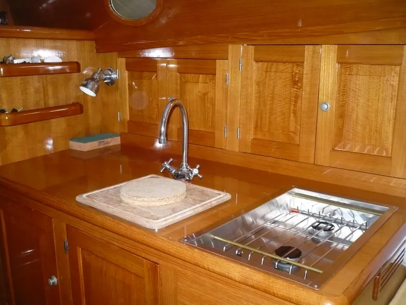 Slide: The Image of Wooden kitchen interior of 1999 Classic Coaster Picnic Boat with sink and stove. - 9