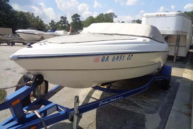 Slide: The Image of 2005 Stingray 180RX boat on trailer, covered and parked outdoors. - 5