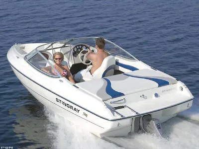 Slide: The Image of 2005 Stingray 180RX boat cruising on open water with two passengers. - 7