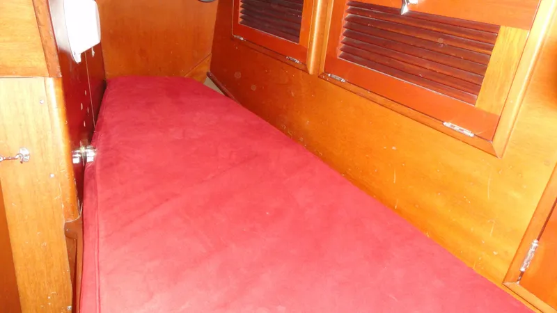 Slide: The Image of 1980 Hinckley 43 interior with red cushioned seating and wooden paneling. - 25