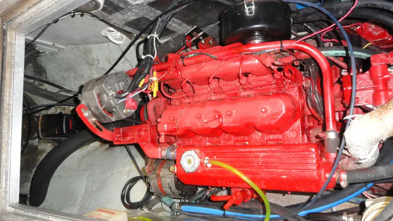 Slide: The Image of Red engine of a 1980 Hinckley 43 boat, showcasing intricate mechanical components. - 38